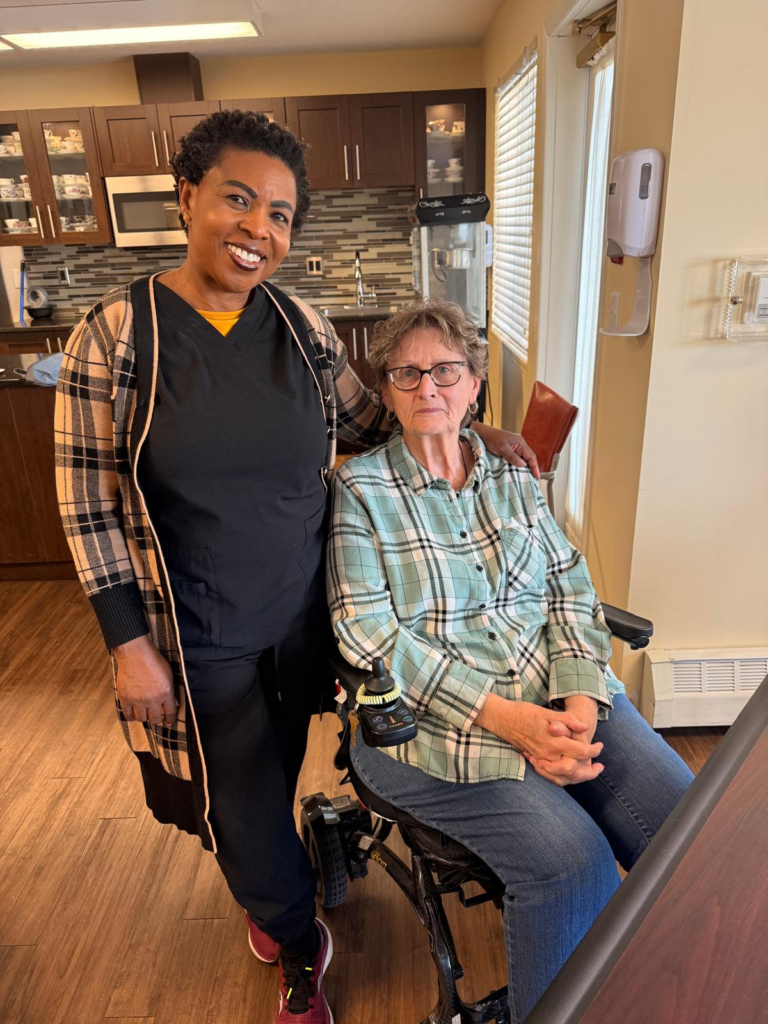 Tinalas caregiver standing with a client at home